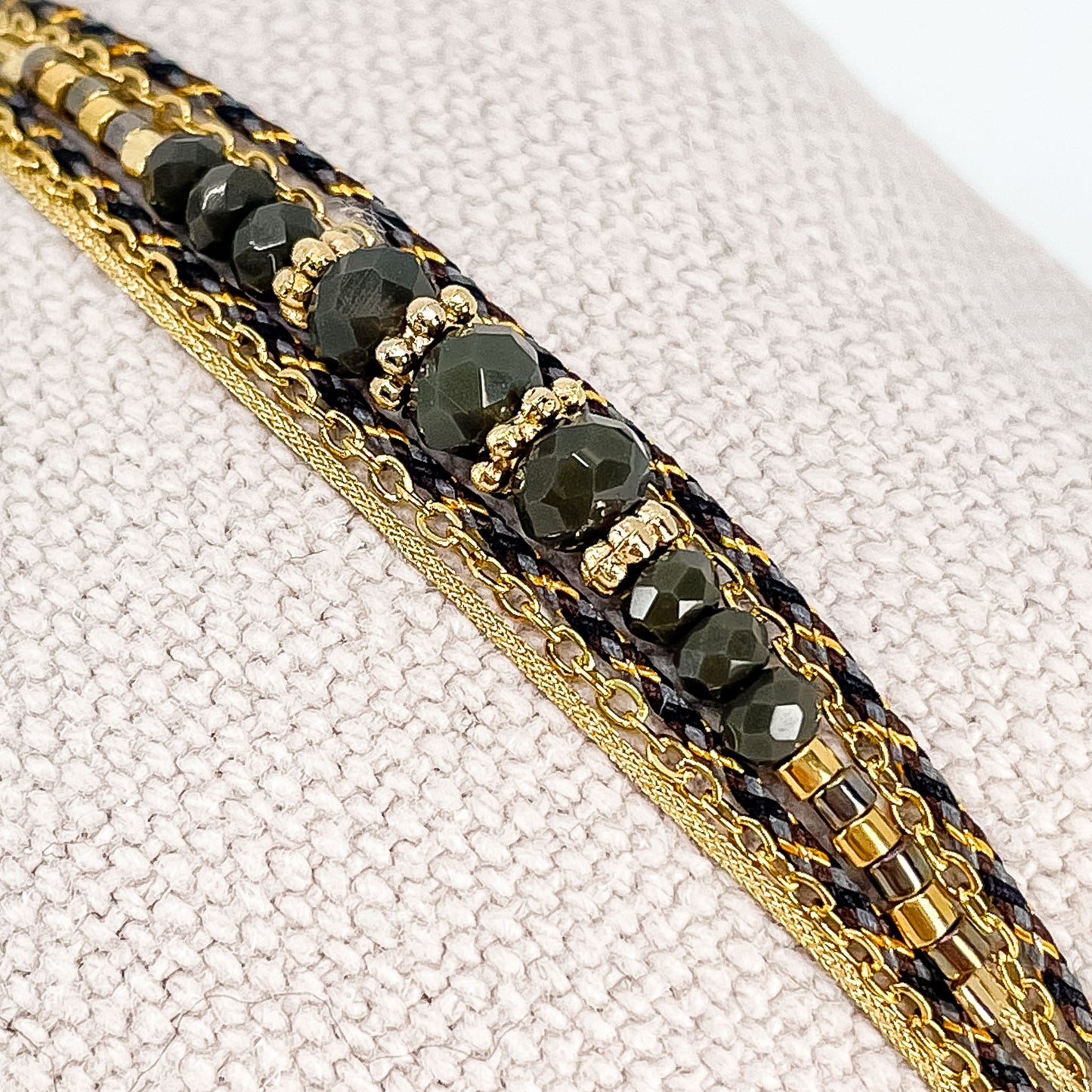 Bracelet en perles de cristal de verre Kaki foncé. Trois liens de cordons et chaîne qui s'enroulent en deux tours sur le poignet.