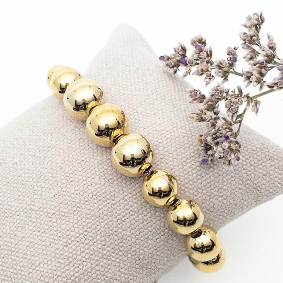 Bracelet perles boules tailles variées - plaqué or - finition miroir