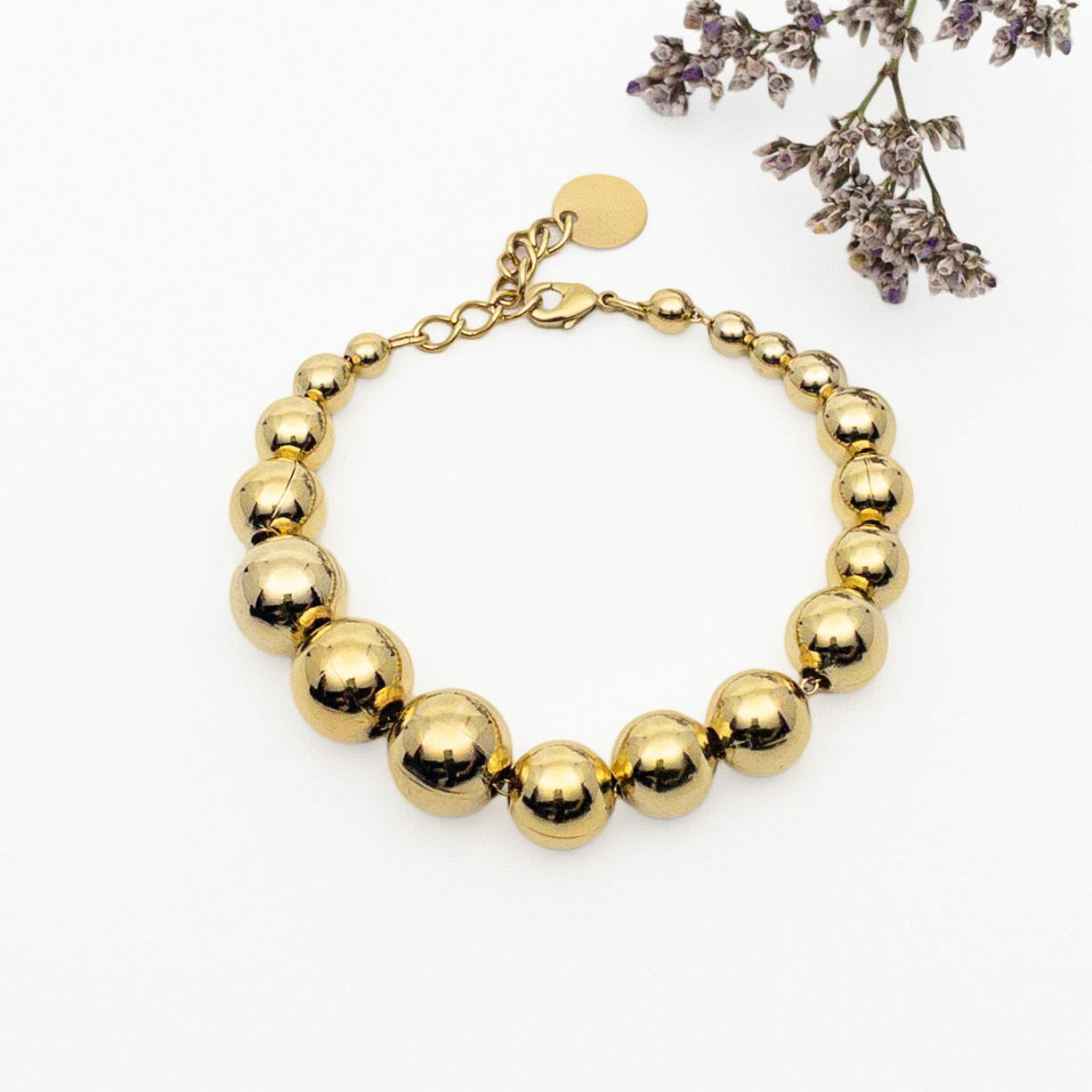 Bracelet perles boules tailles variées - plaqué or - finition miroir