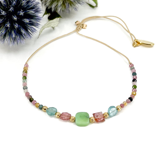 Bracelet ajustable en pierres fines naturelles. Au centre une Agathe d'Herbe carrée verte. Encadrée de deux Tourmalines et deux Aigue-marine.