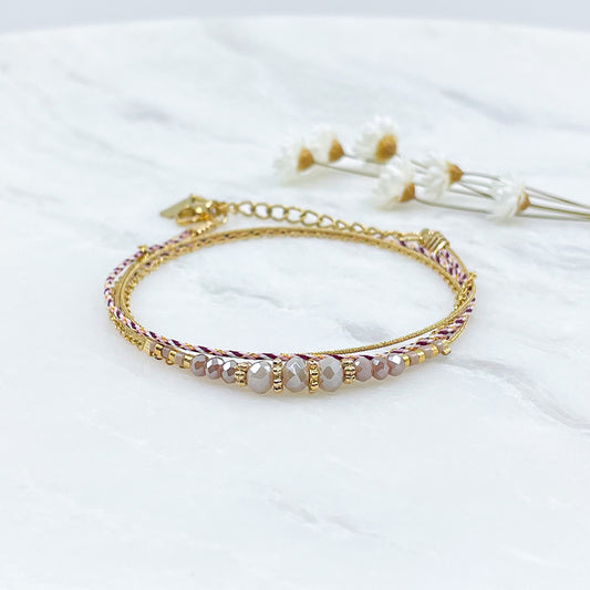 Bracelet composé de 3 liens en cordons colorés et doré et chaîne dorée. Sur l'un d'eux sont montées des perles de verre de Cristal Rose et Rose pâle aux beaux reflets.