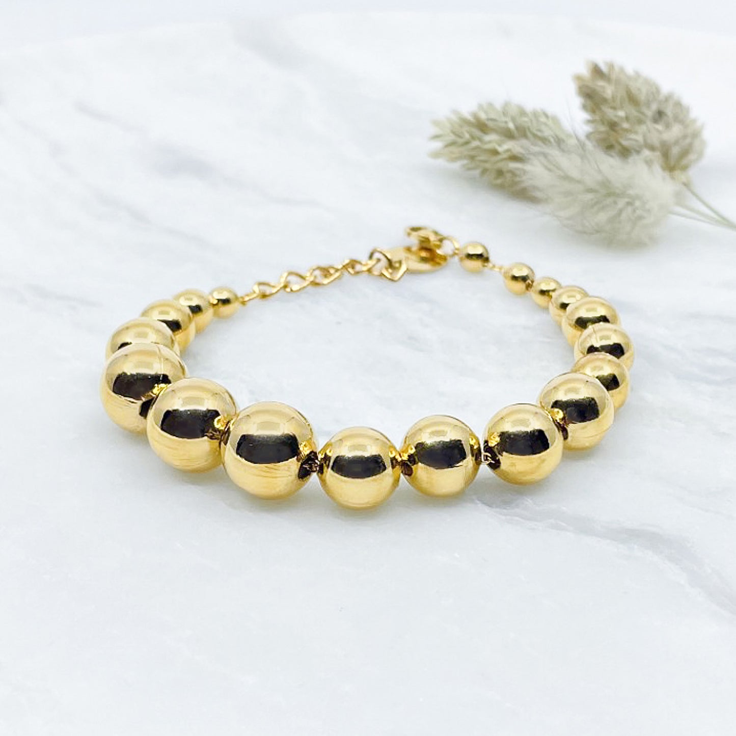 Bracelet perles boules tailles variées - plaqué or 