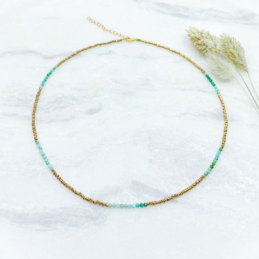 Collier en pierres fines naturelles d'amazonite aux différentes teintes de vert et hématite dorée. Longueur ajustable de 38-43 cm. Fermoir et chaîne d'extension en plaqué or.